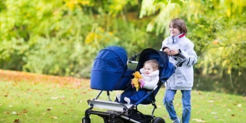 Happy smiling boy walking with his little siblings, a cute curly Happy smiling boy walking with his little siblings, a cute curly